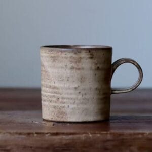Handcrafted ceramic coffee mug with a rustic speckled glaze